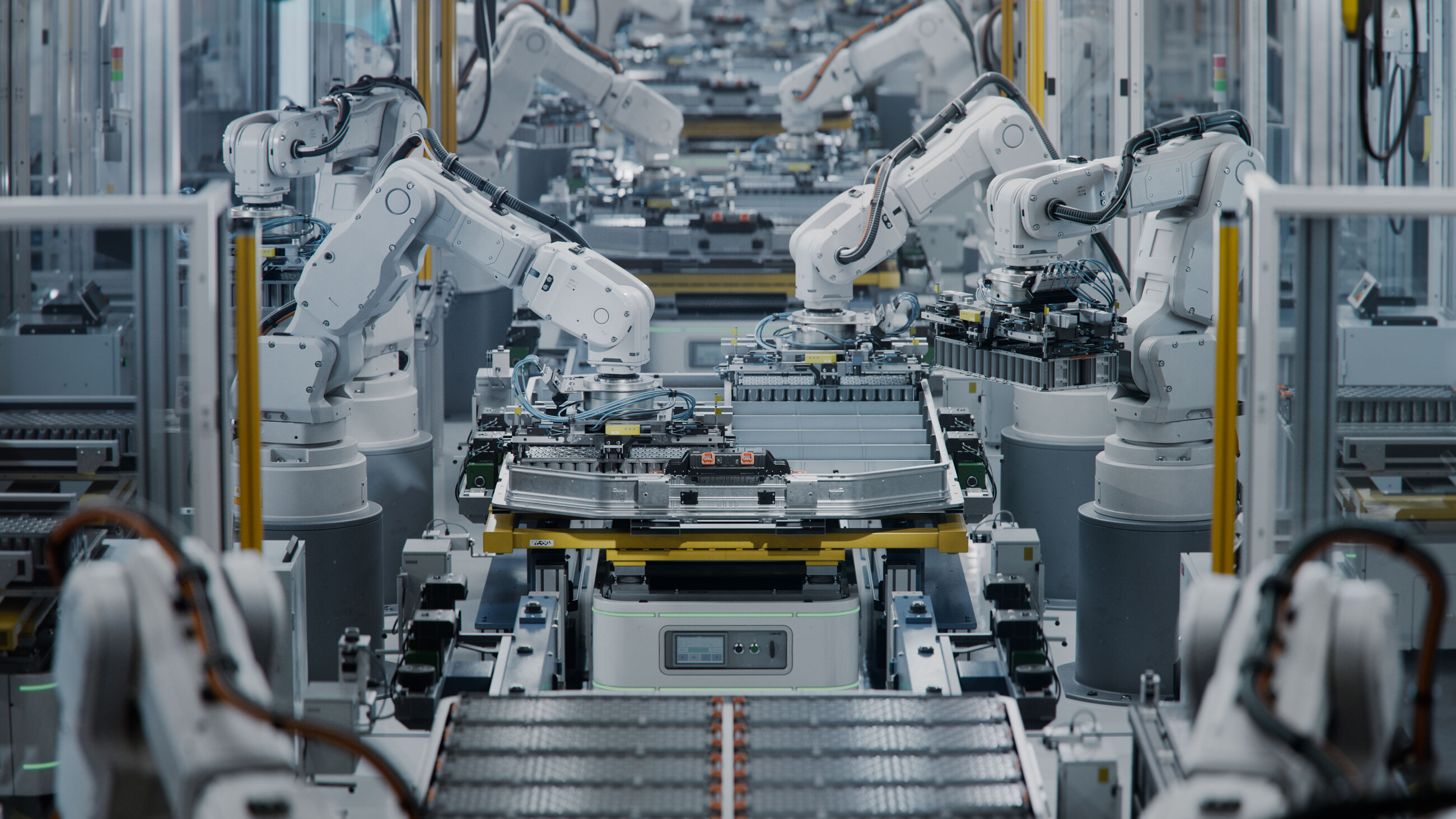 Bras robotisés blancs alignés au-dessus d'une ligne d'assemblage automatisée